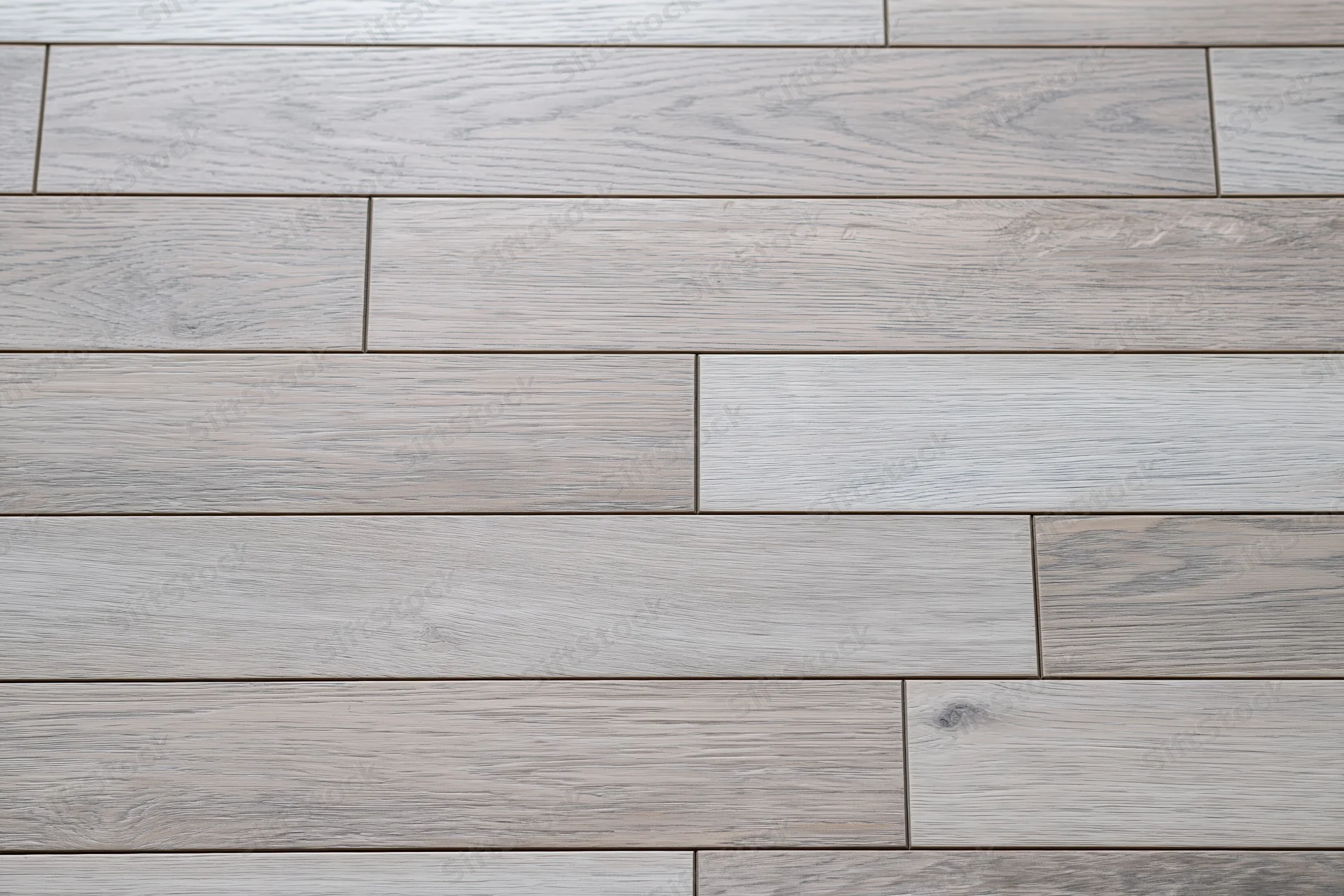 Light grey engineered oak hardwood flooring arranged in staggered planks for interior flooring