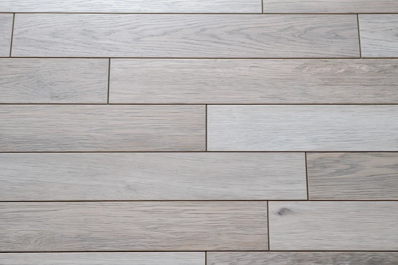 Light grey engineered oak hardwood flooring arranged in staggered planks for interior flooring