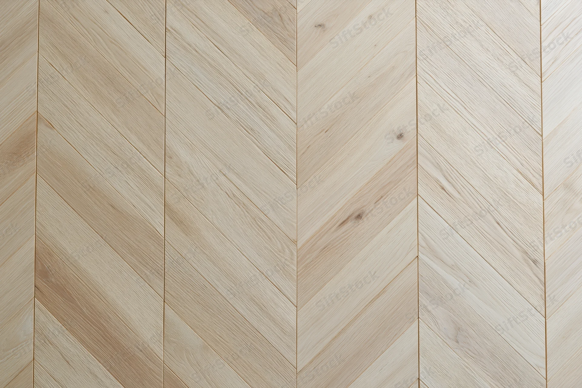 Light oak parquet flooring arranged in a chevron pattern for interior design