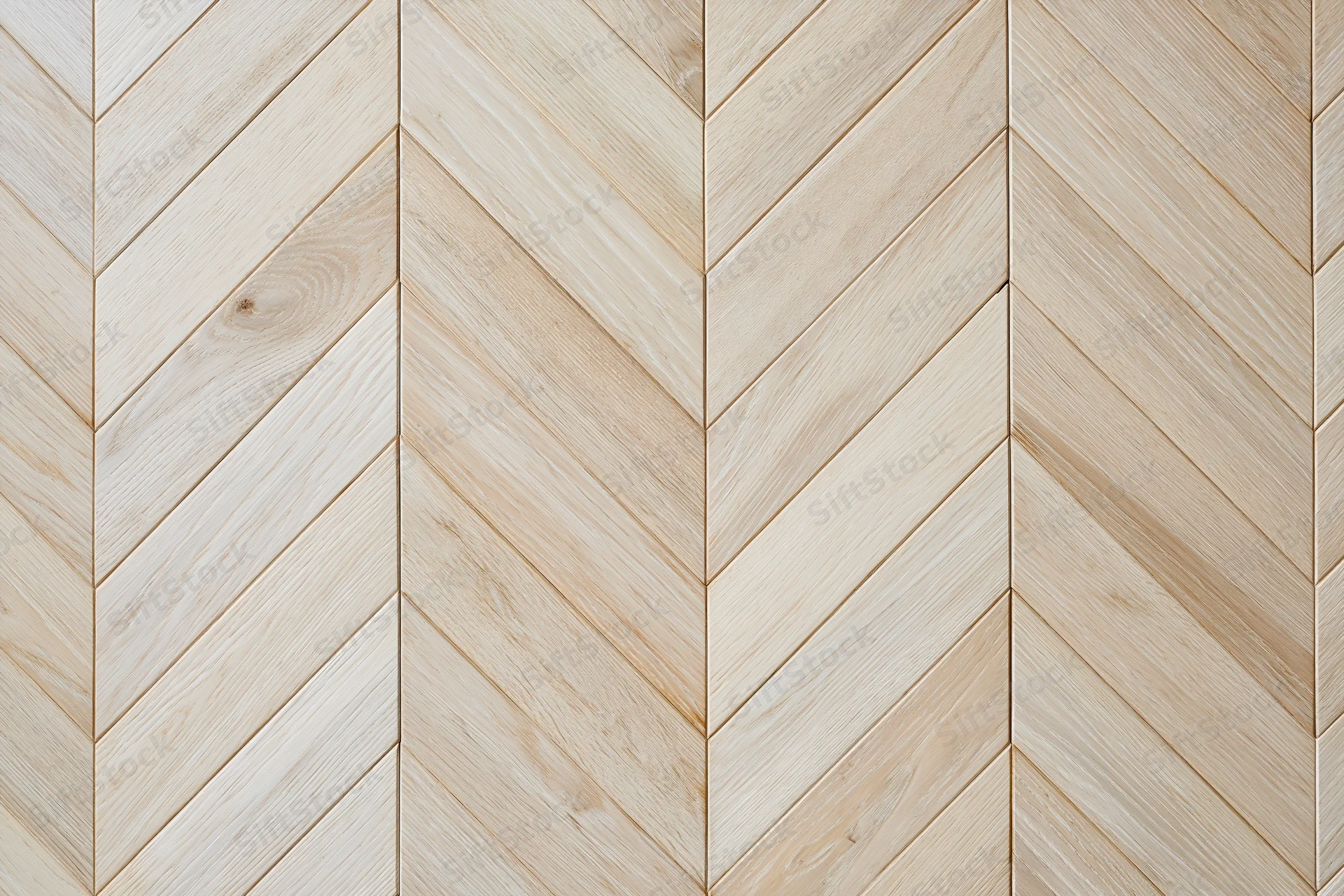 Light oak parquet flooring arranged in a chevron pattern for interior use
