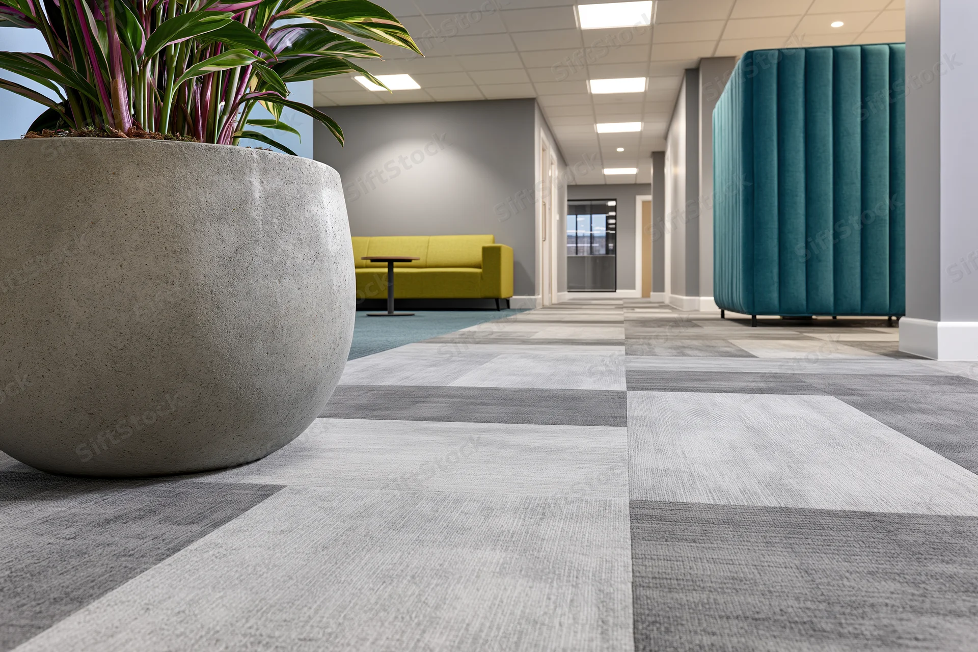 Modern office corridor with patterned carpet tiles and seating areas