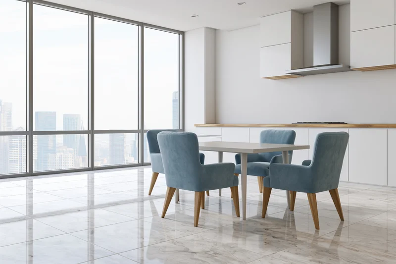 Modern open-plan kitchen and dining area with city view through floor-to-ceiling windows