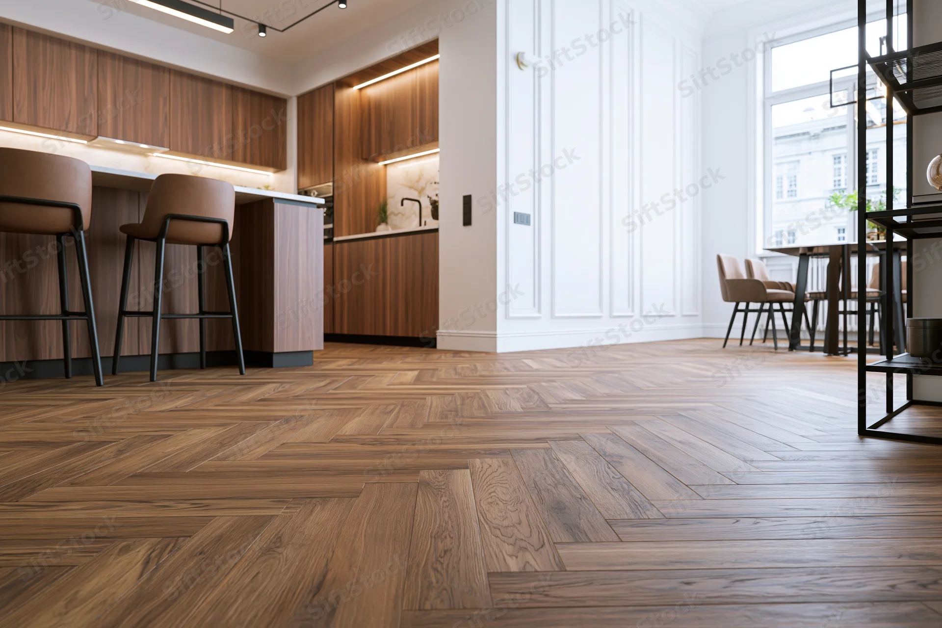 Modern open-plan kitchen and dining area with wood herringbone flooring and white paneling