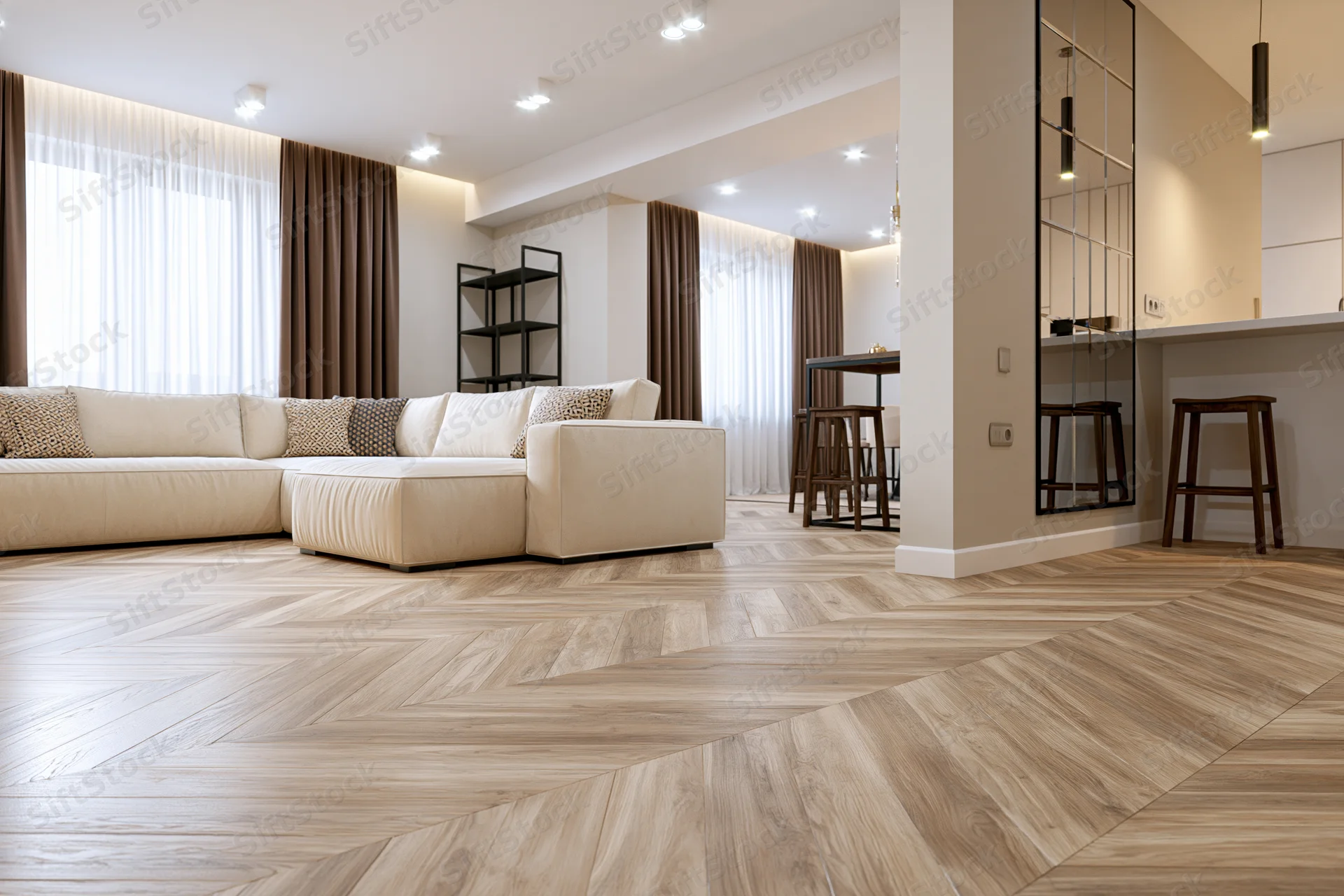 Modern open-plan living room with beige sectional sofa and herringbone wood flooring viewed from low angle