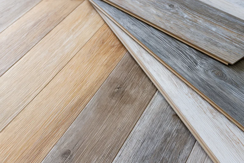 Wood flooring sample planks fanned out diagonally on a floor surface