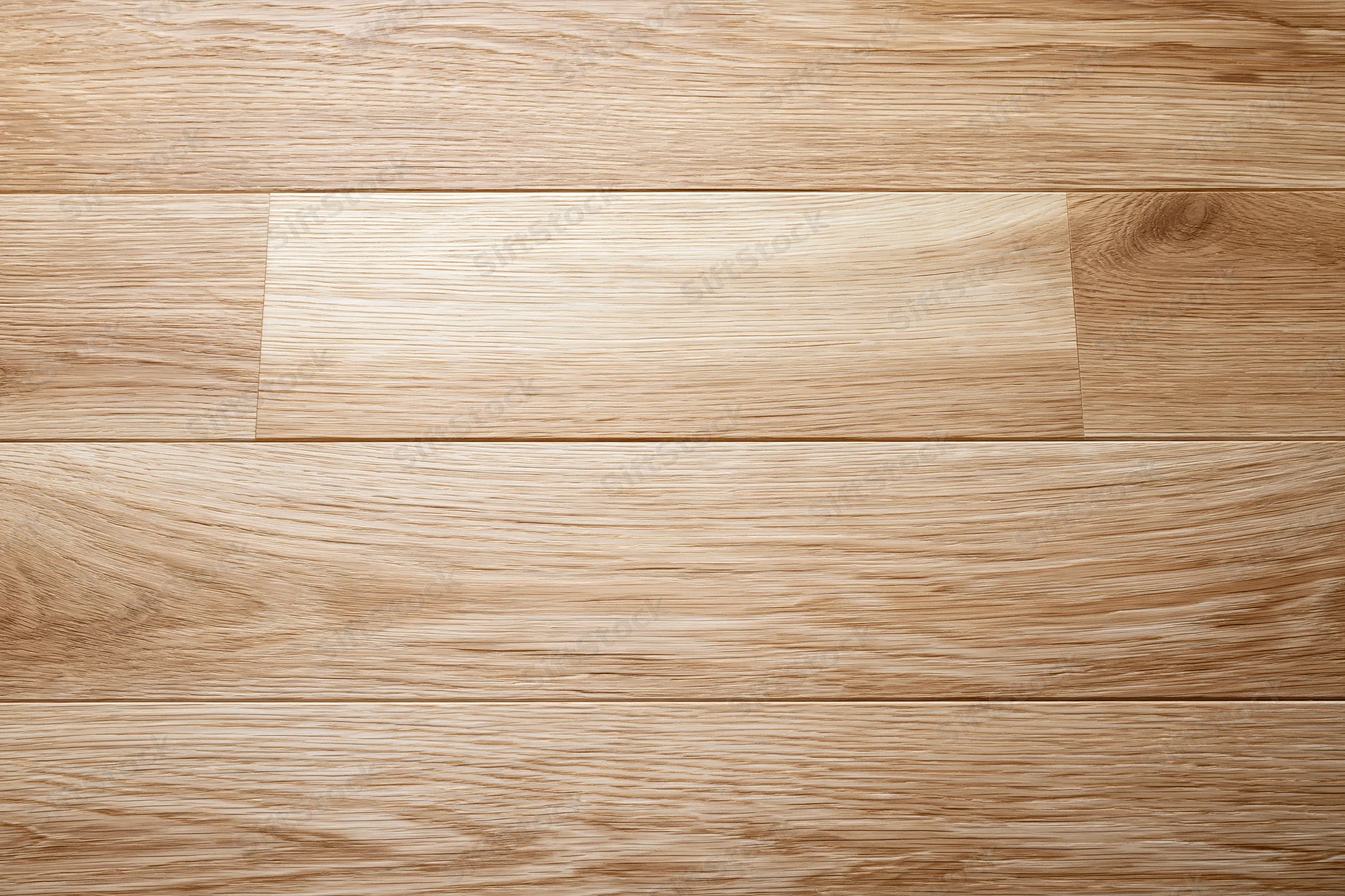 Overhead view of light oak hardwood floor planks arranged in horizontal rows across a smooth interior surface