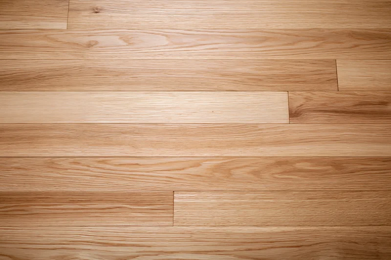 Light oak hardwood floor planks arranged in parallel rows across a smooth interior surface