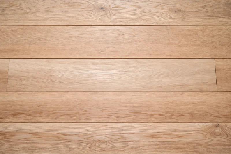 Overhead view of light oak hardwood floor planks arranged horizontally in a seamless pattern