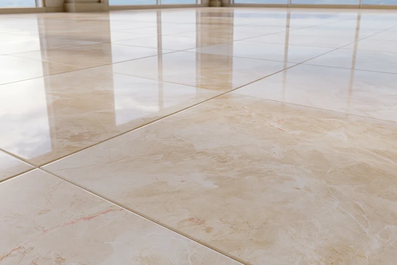 Polished marble tile floor reflecting light in a spacious interior