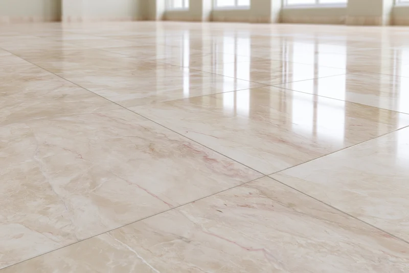 Polished marble tile floor stretching toward windows in a spacious interior