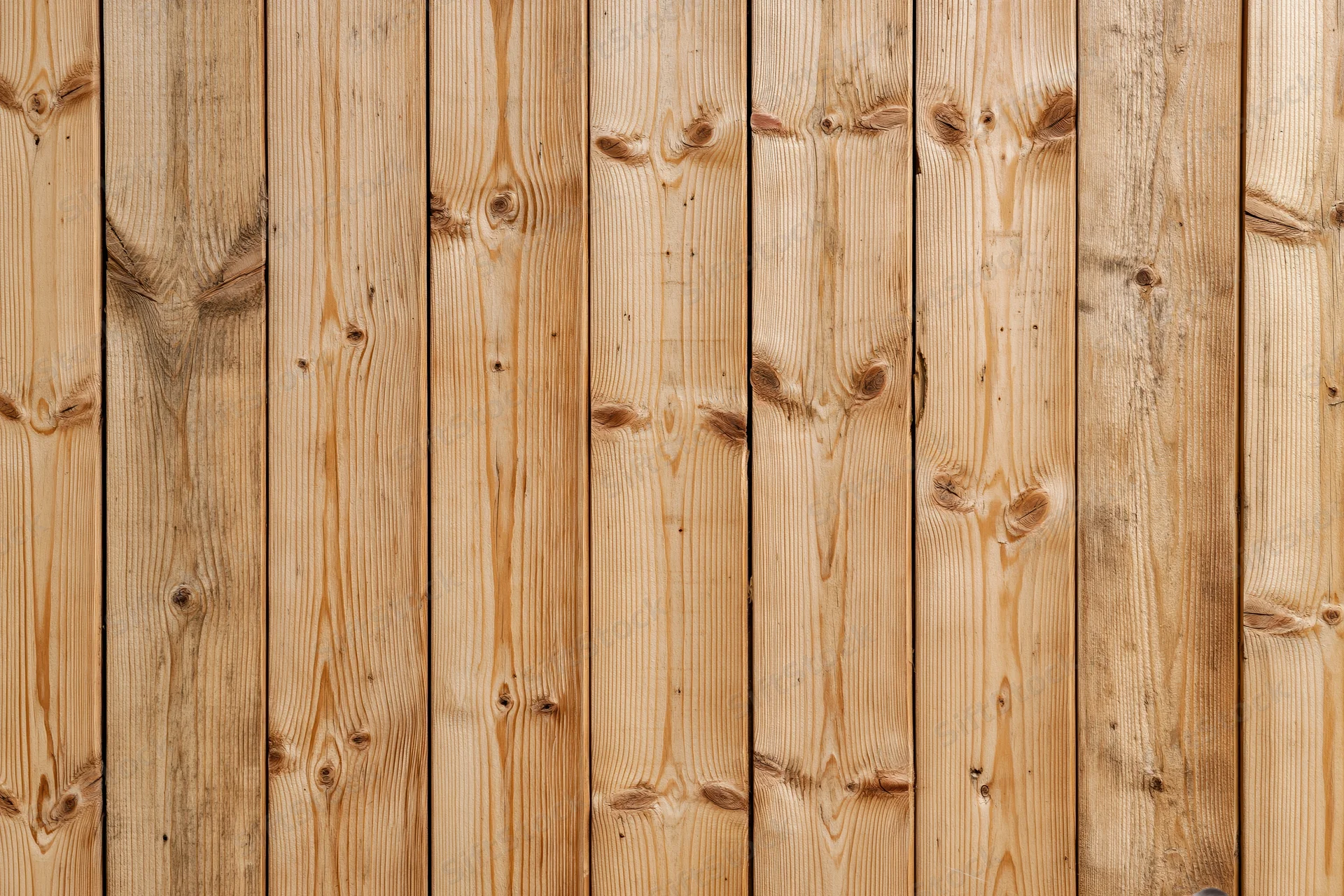 Vertical pine wood planks arranged in a flat-on view filling the frame as a textured background