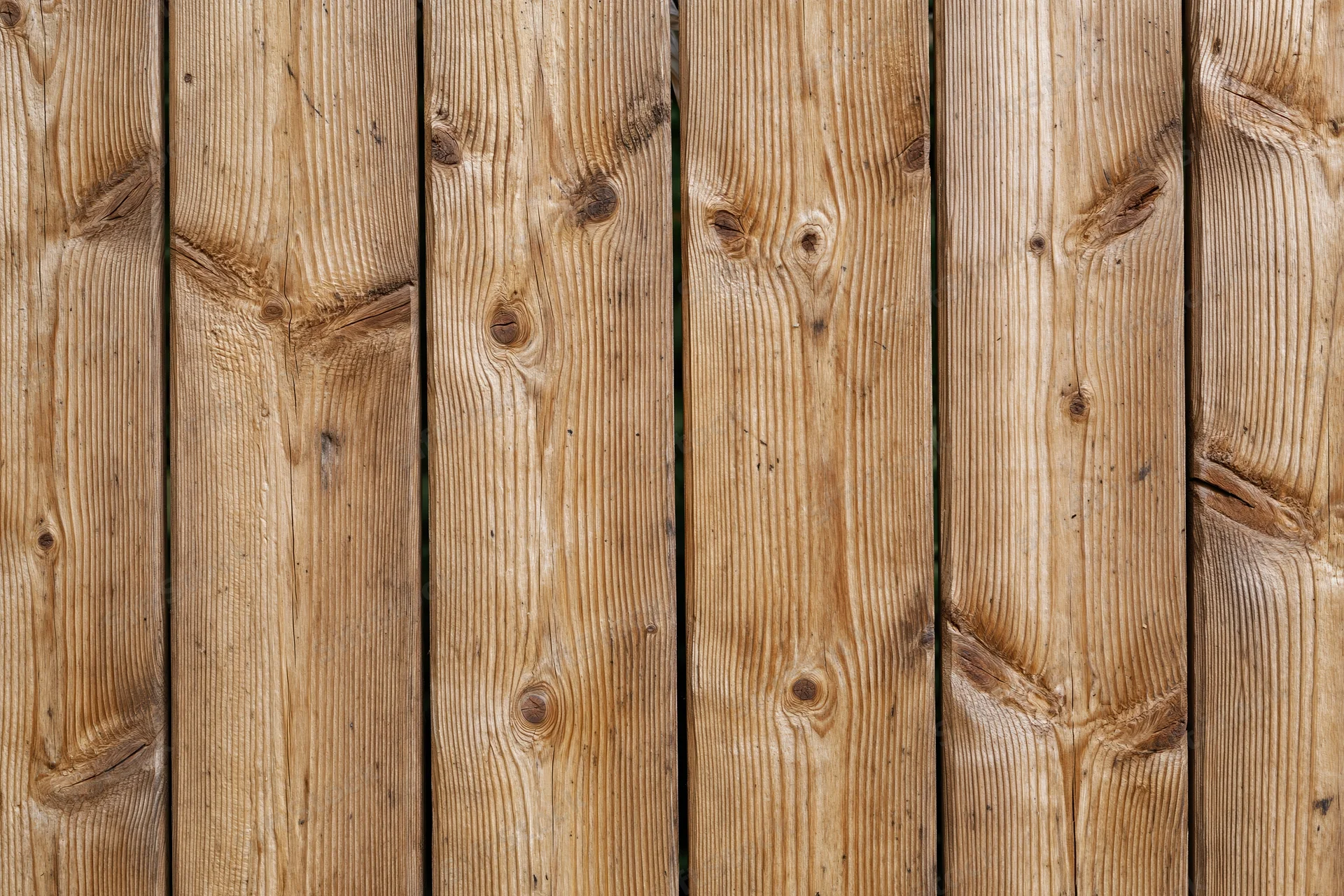 Vertical pine wood planks arranged in a flat-on view filling the frame