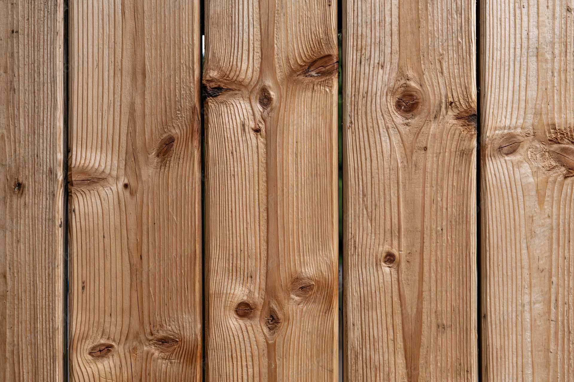 Vertical pine wood planks arranged flat-on filling the frame as a textured surface