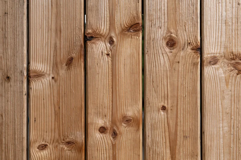 Vertical pine wood planks arranged flat-on filling the frame as a textured surface