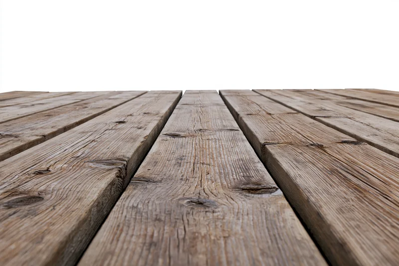 Weathered wooden deck planks arranged horizontally receding into the distance on a white background