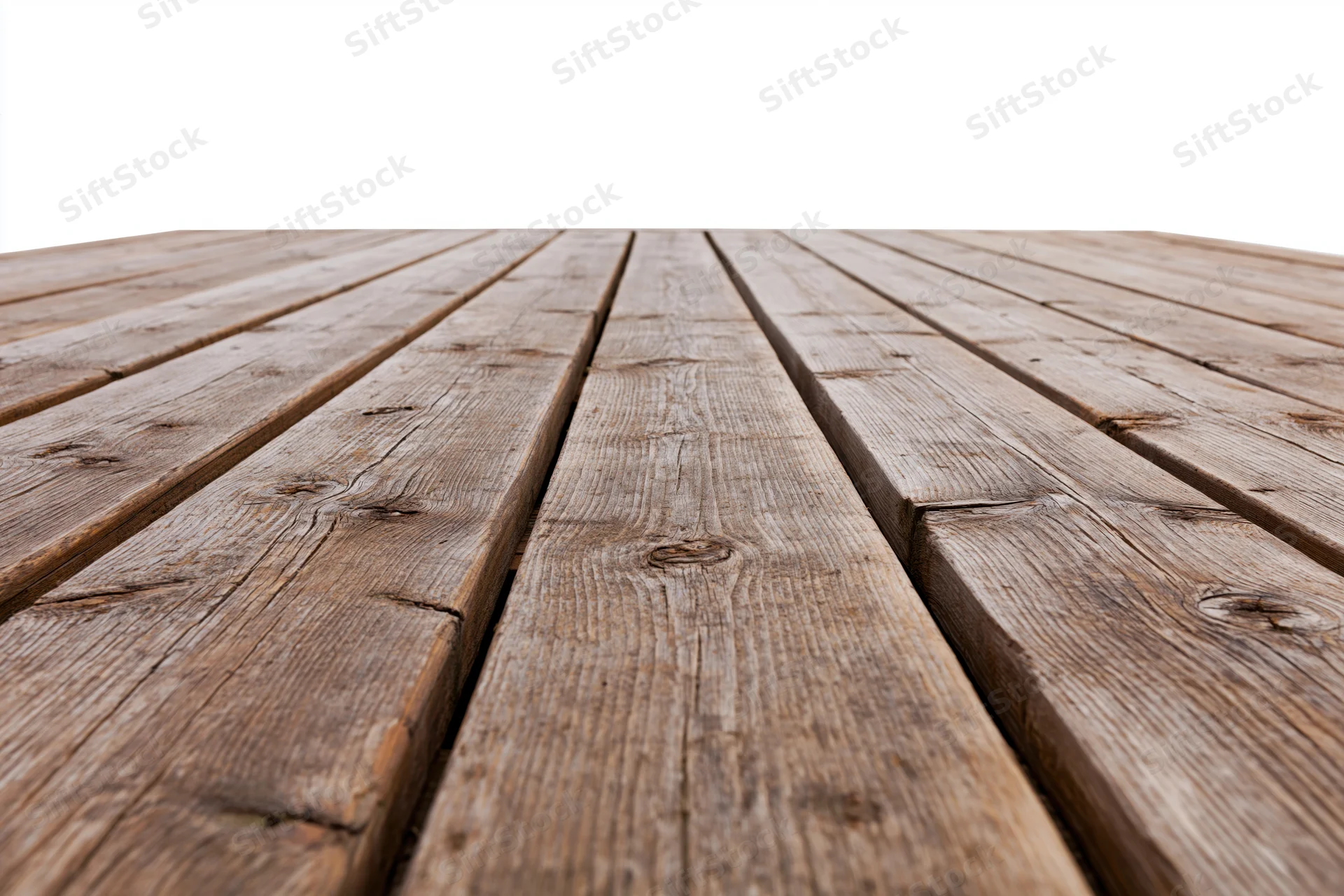 Weathered wooden deck planks arranged in parallel rows receding into the distance on an outdoor surface