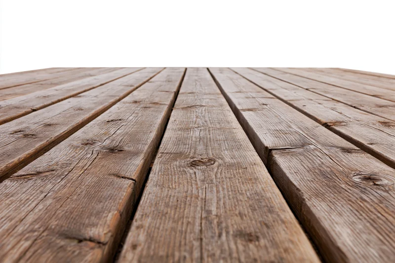 Weathered wooden deck planks arranged in parallel rows receding into the distance on an outdoor surface