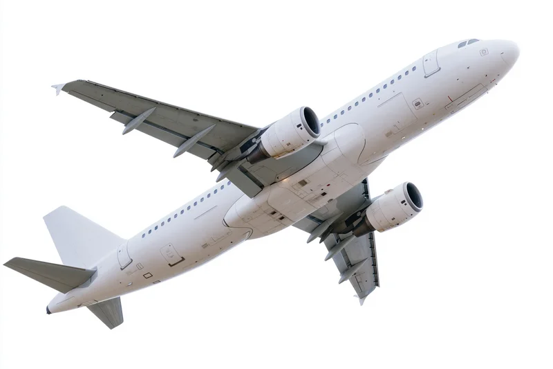 White commercial passenger jet climbing after takeoff against clear sky