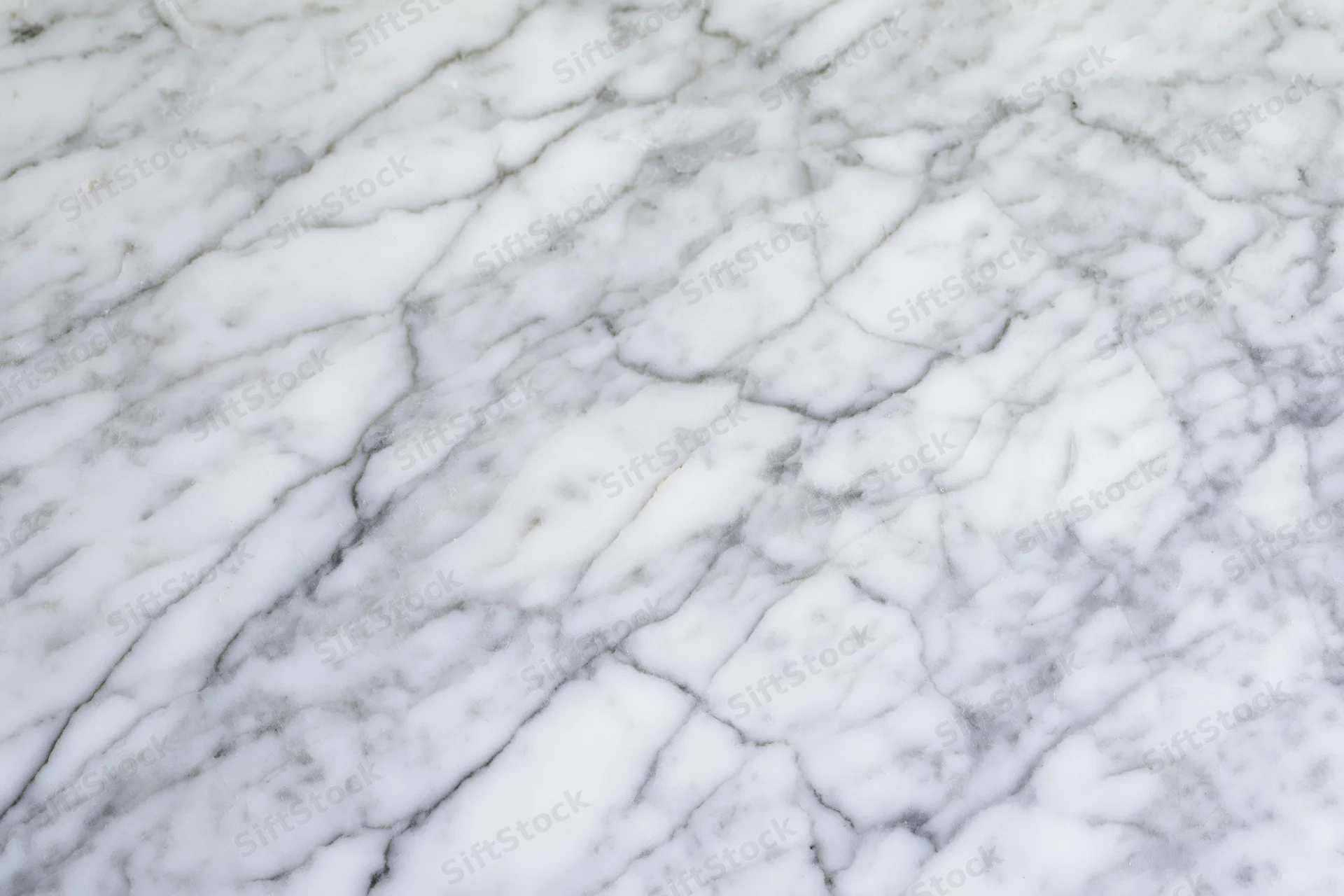 White marble surface with gray veining filling the frame in flat-lay view