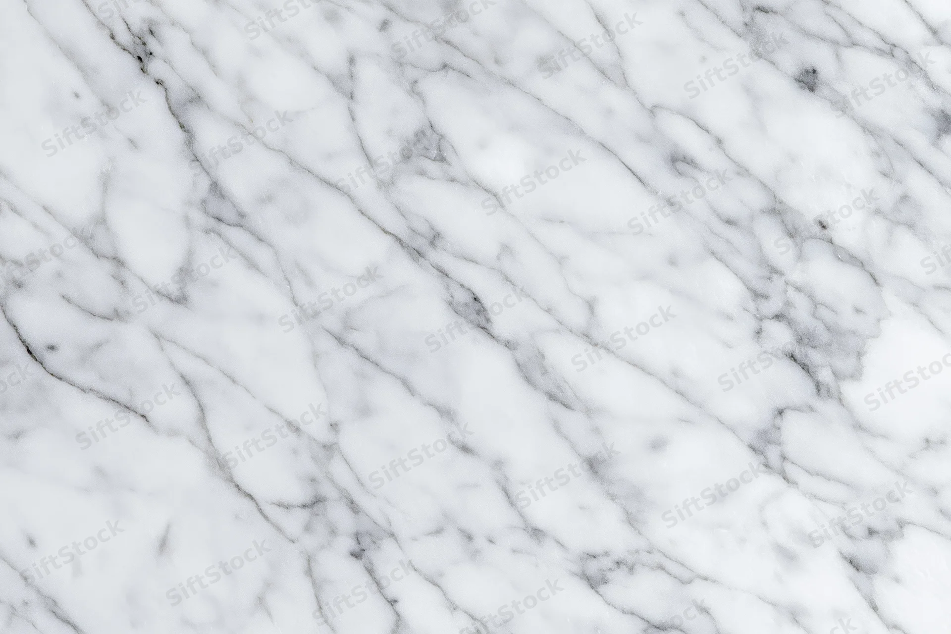 White marble surface with gray veining filling the frame