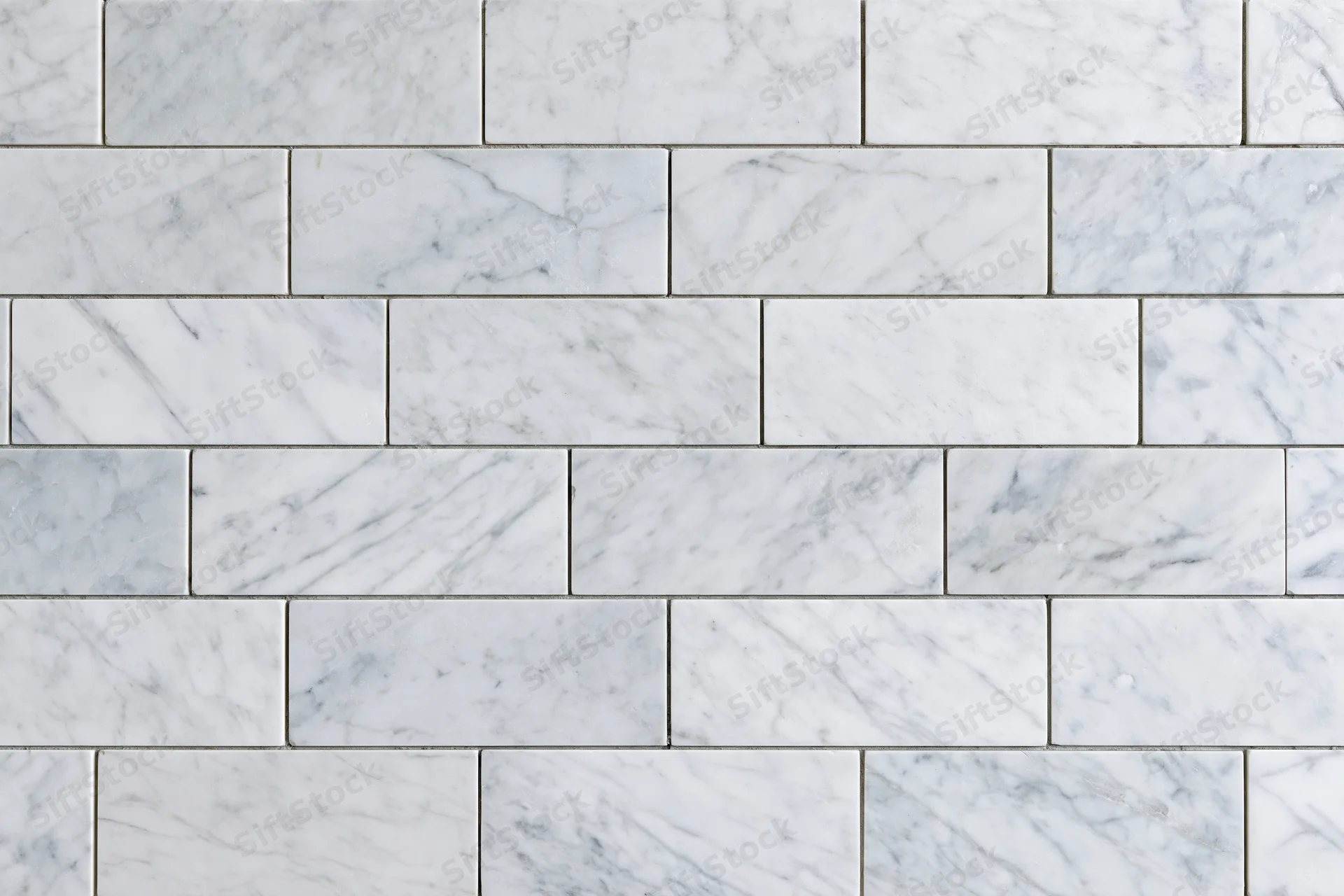 White marble tile wall surface filling the entire frame