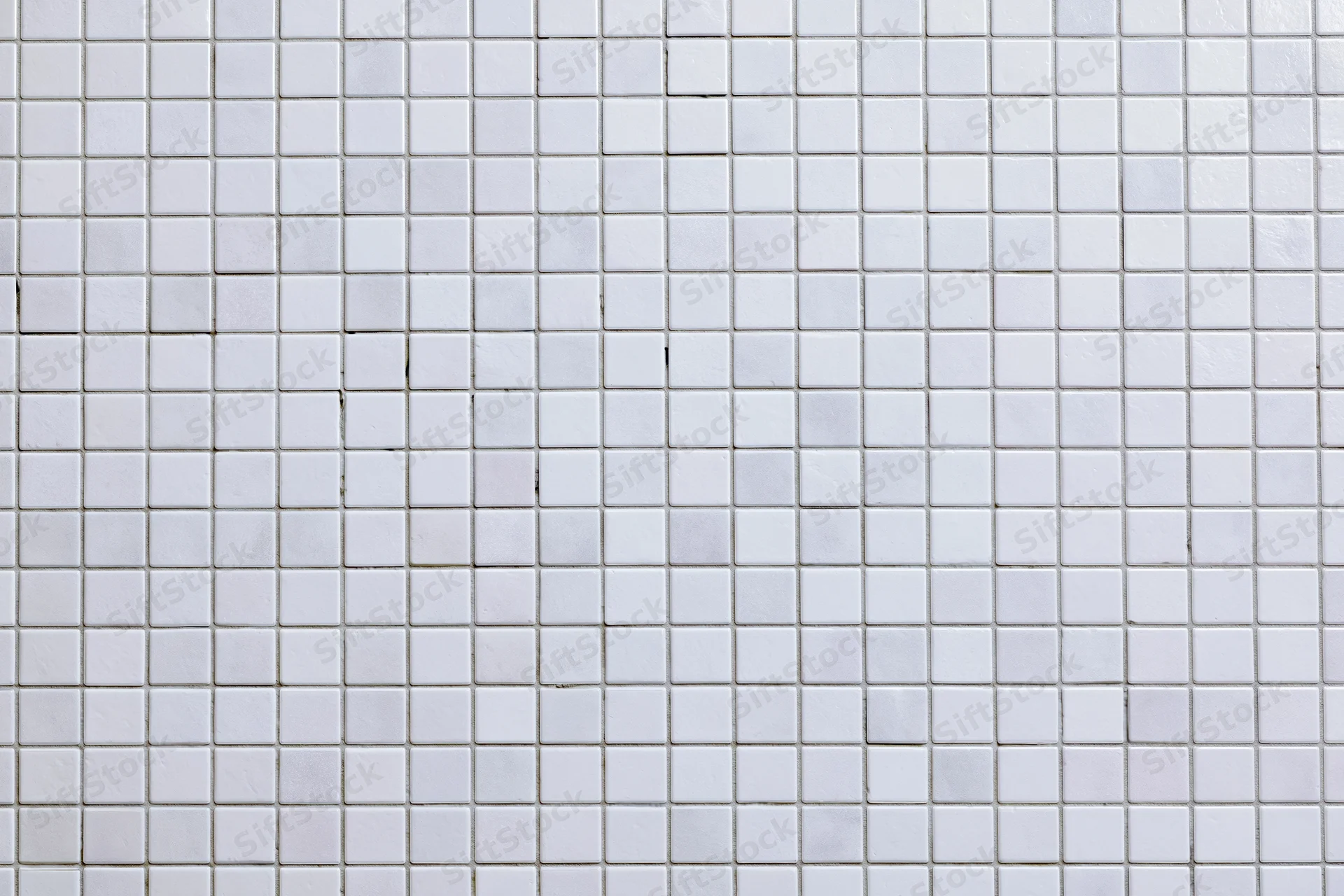 White small square mosaic tile wall surface filling the frame