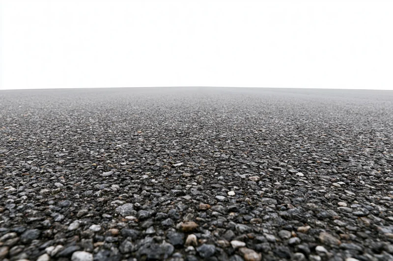Wide low-angle view of flat empty asphalt surface stretching to horizon