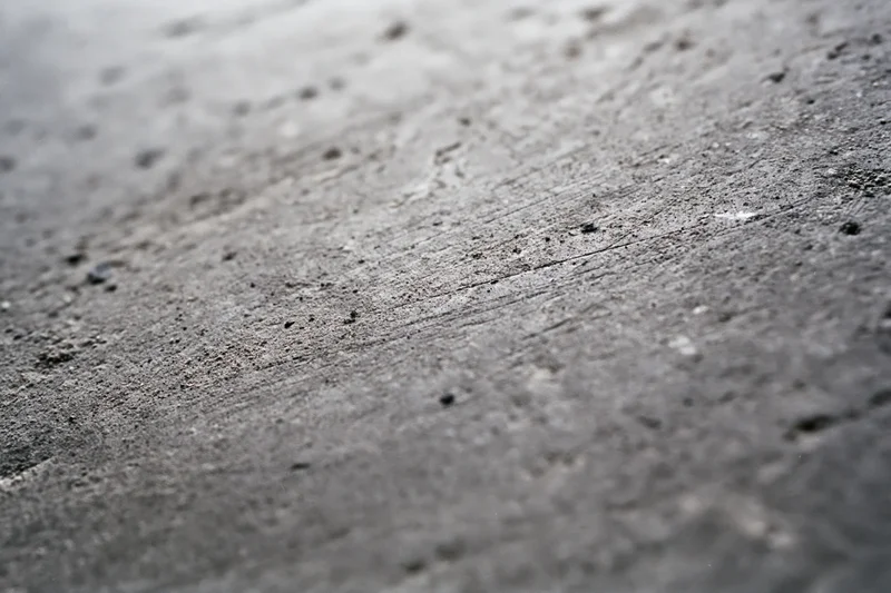 Worn concrete floor surface viewed from low diagonal angle