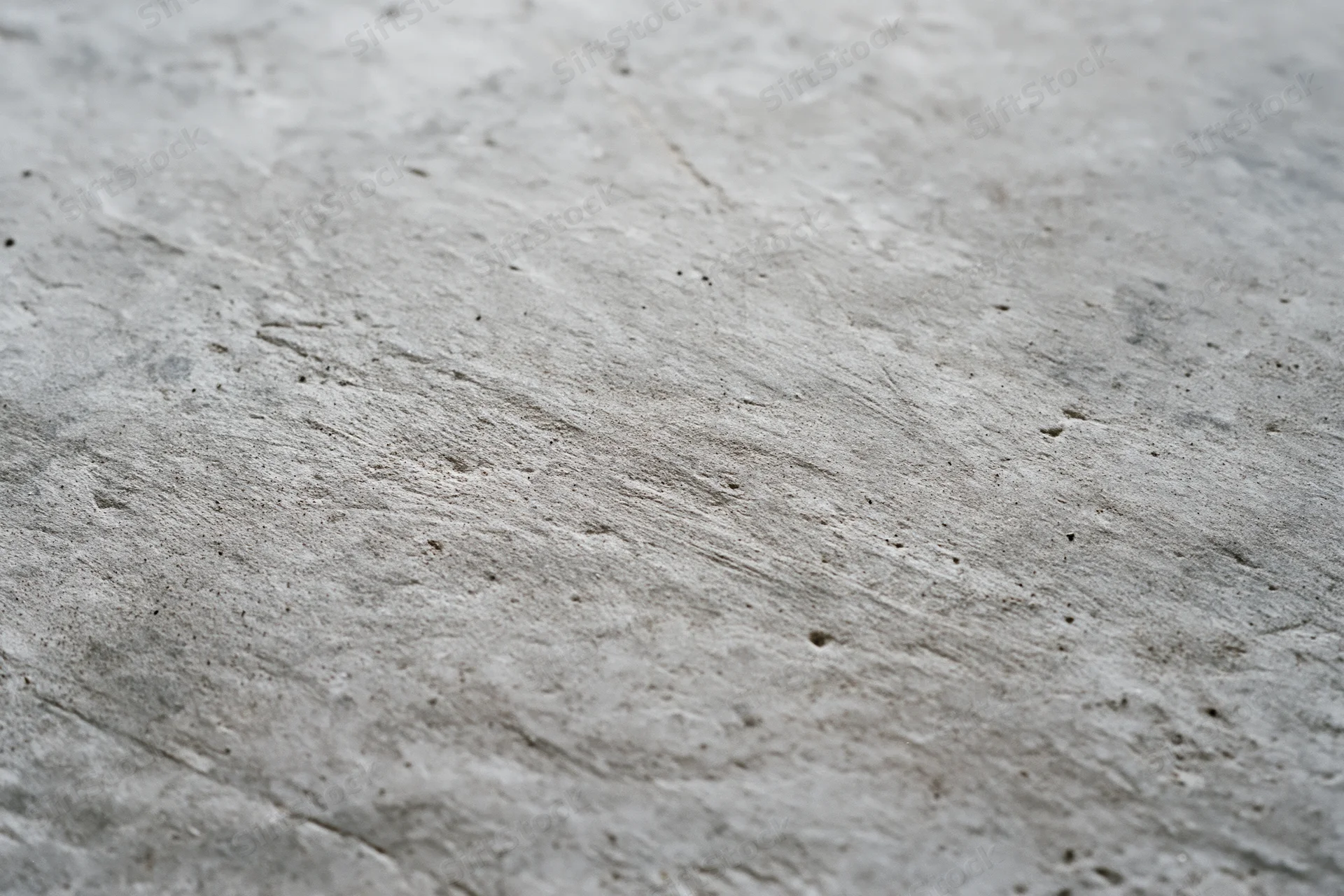 Worn concrete floor surface viewed from low diagonal angle