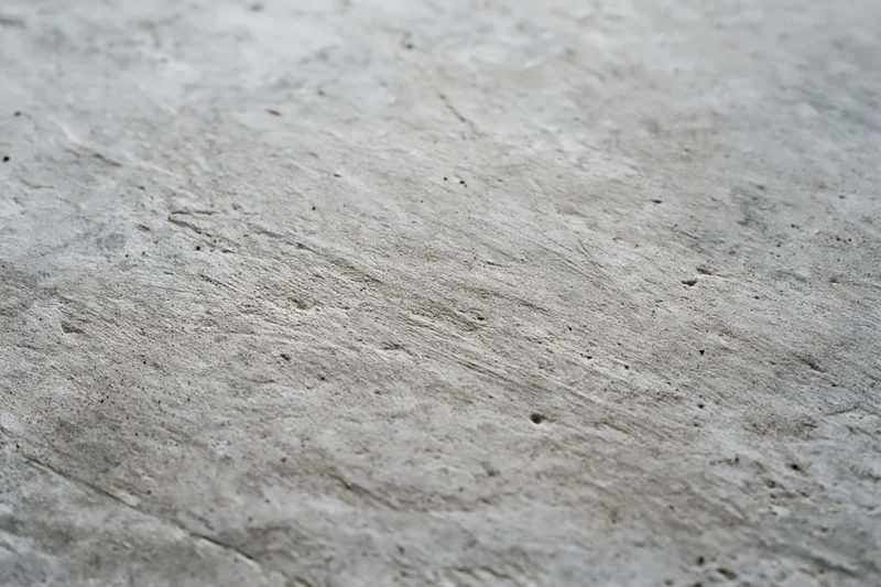 Worn concrete floor surface viewed from low diagonal angle
