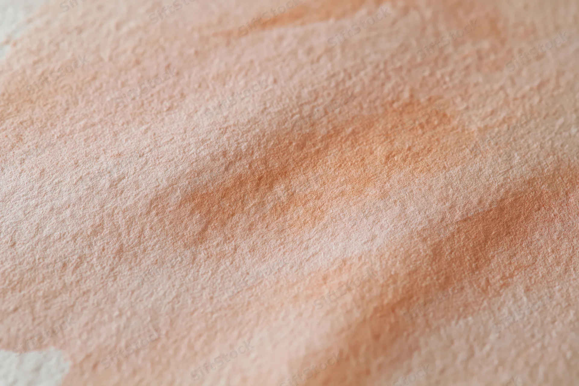 Close-up of watercolor paint texture on canvas surface