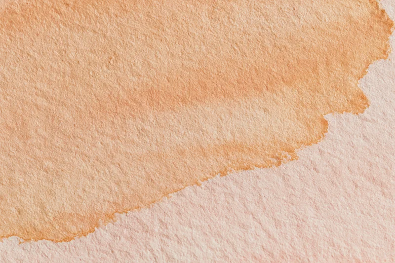 Watercolor wash on textured paper with soft orange gradient and visible edge