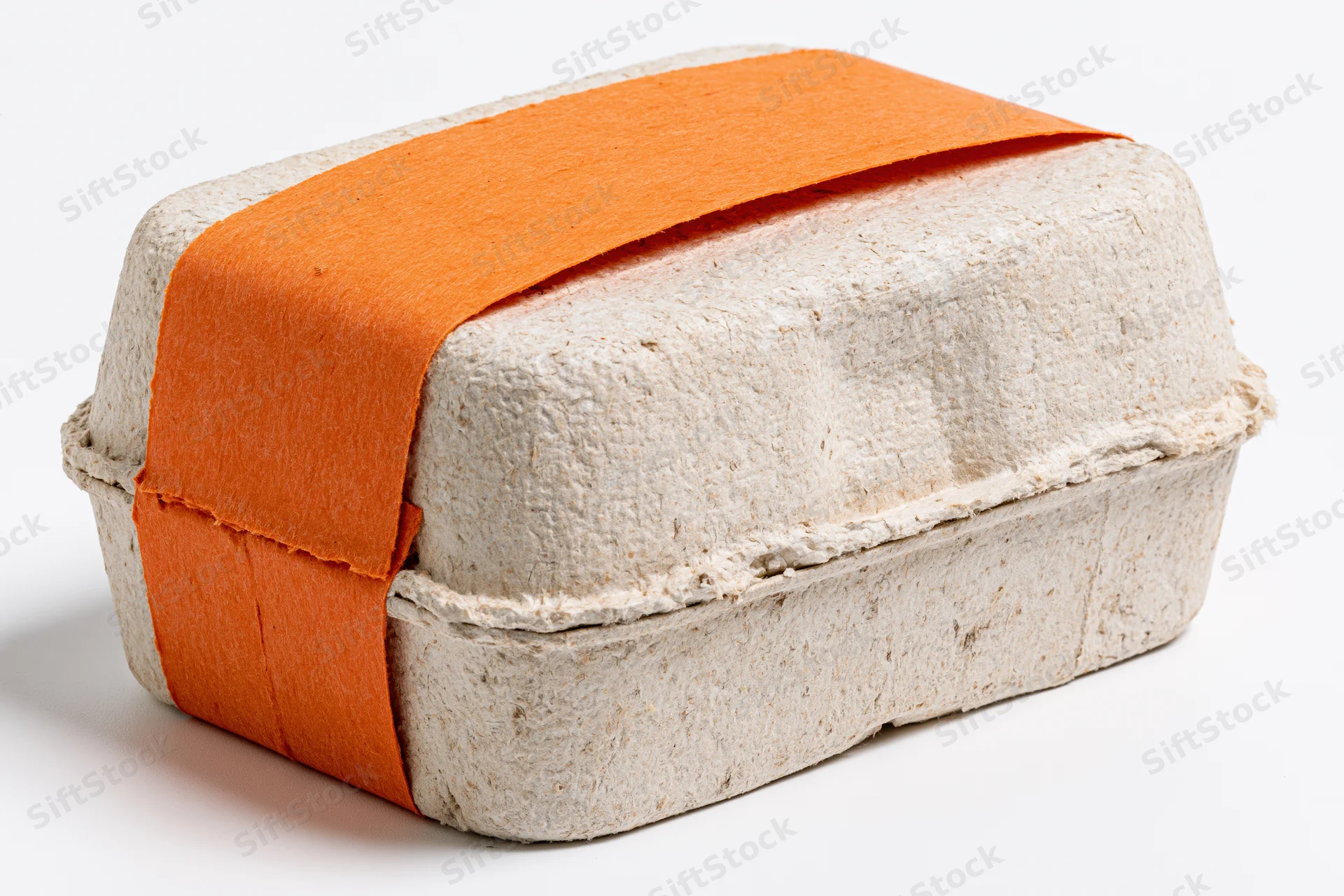 Molded pulp egg carton wrapped with orange paper band on white background