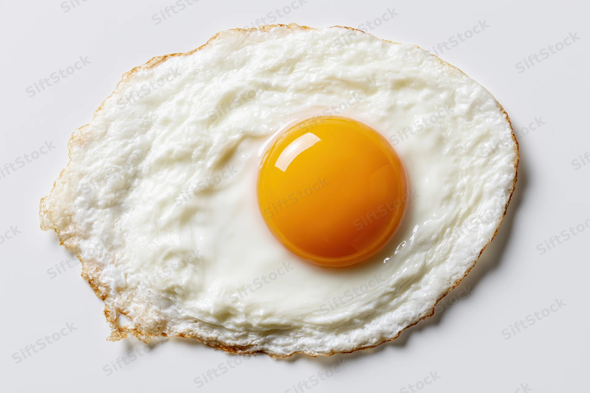 Single fried egg sunny-side up with intact yolk centered on white surface