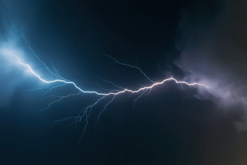 Jagged lightning bolt stretching horizontally across dark stormy sky at night