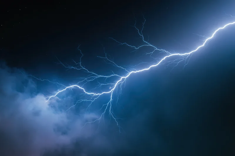 Jagged lightning bolt stretching horizontally across dark stormy sky at night