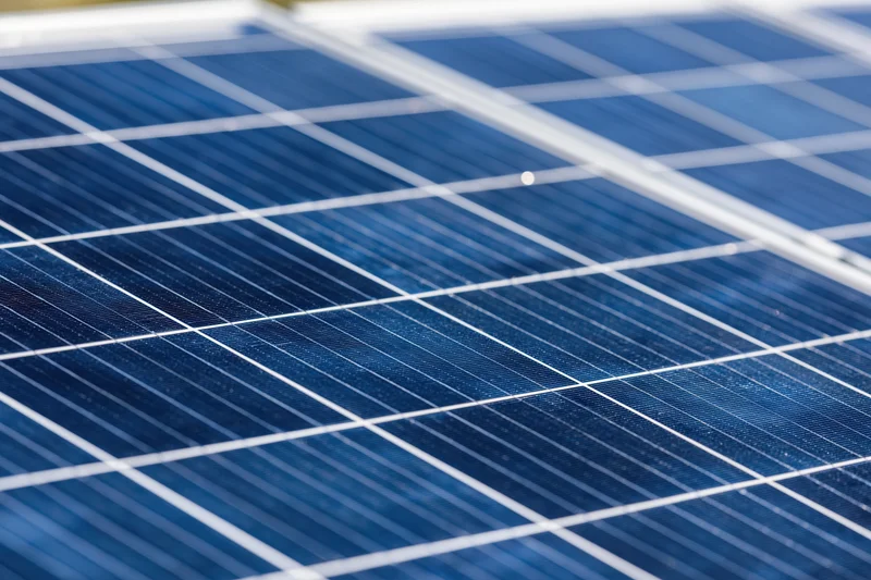 Close-up of solar panel surface showing blue photovoltaic cells and white gridlines
