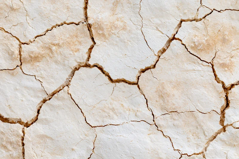 Cracked dried plaster surface in close-up macro view