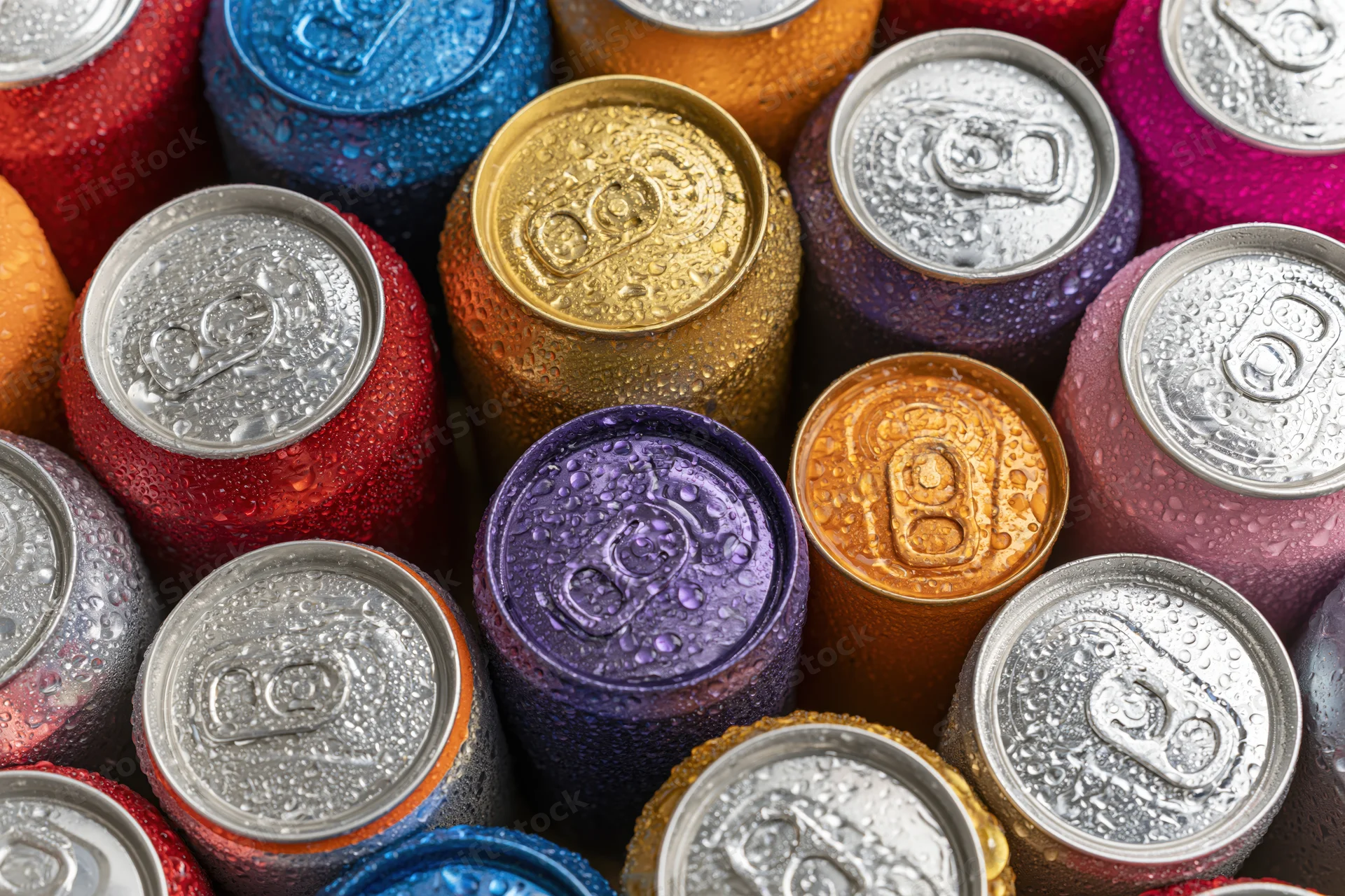 Cold aluminum soda cans packed tightly together from top view