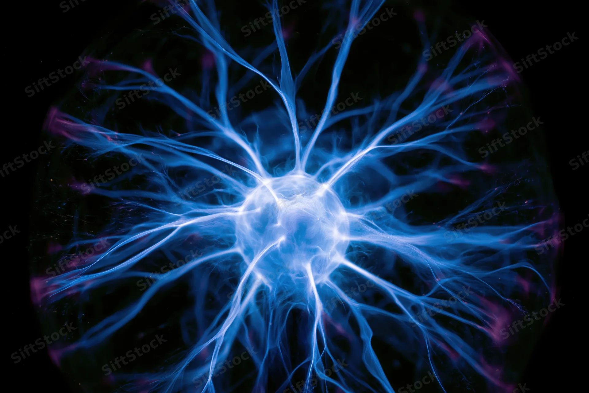 Plasma ball emitting blue electric filaments in a dark laboratory setting