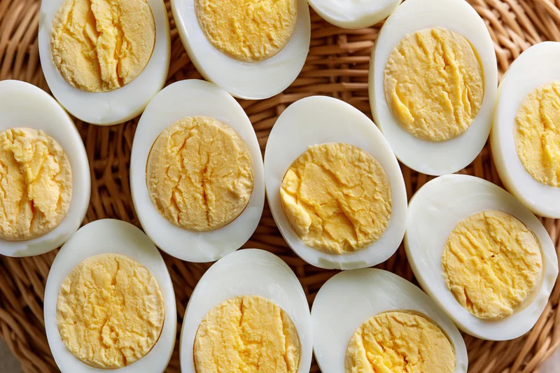 Hardboiled egg halves arranged cut-side up in a wicker basket