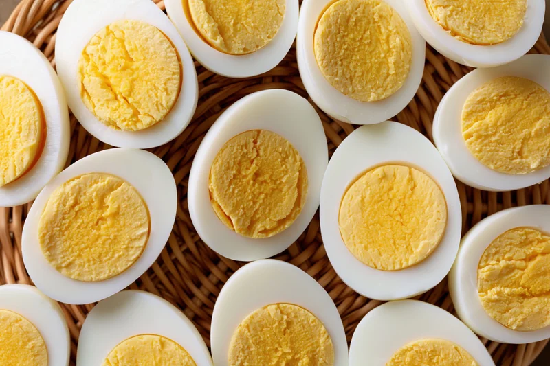 Hard-boiled egg halves arranged cut-side up in a woven basket