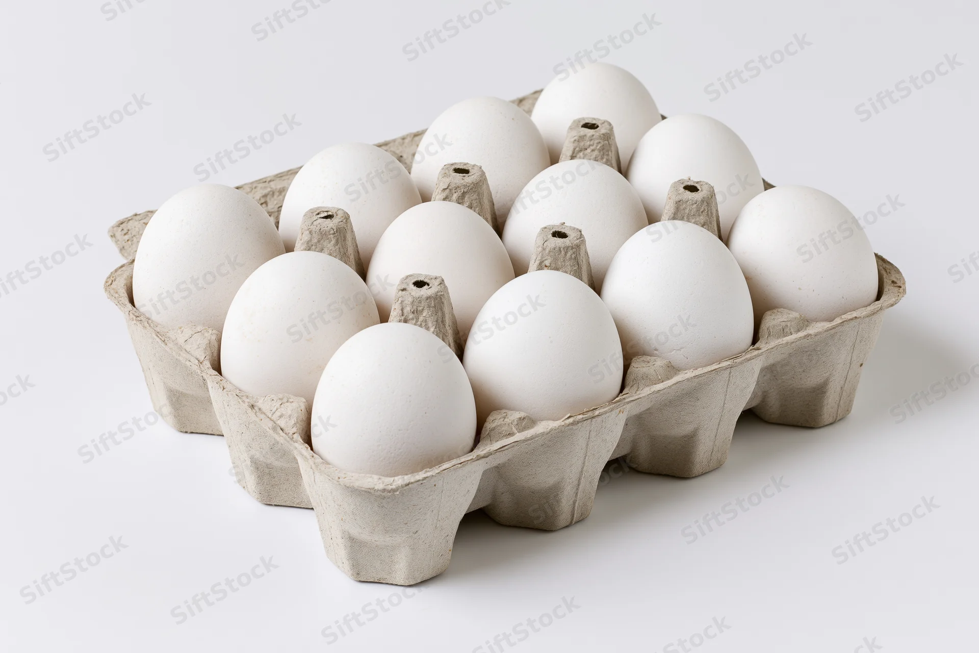 Open cardboard egg carton holding ten white eggs viewed from above on white background
