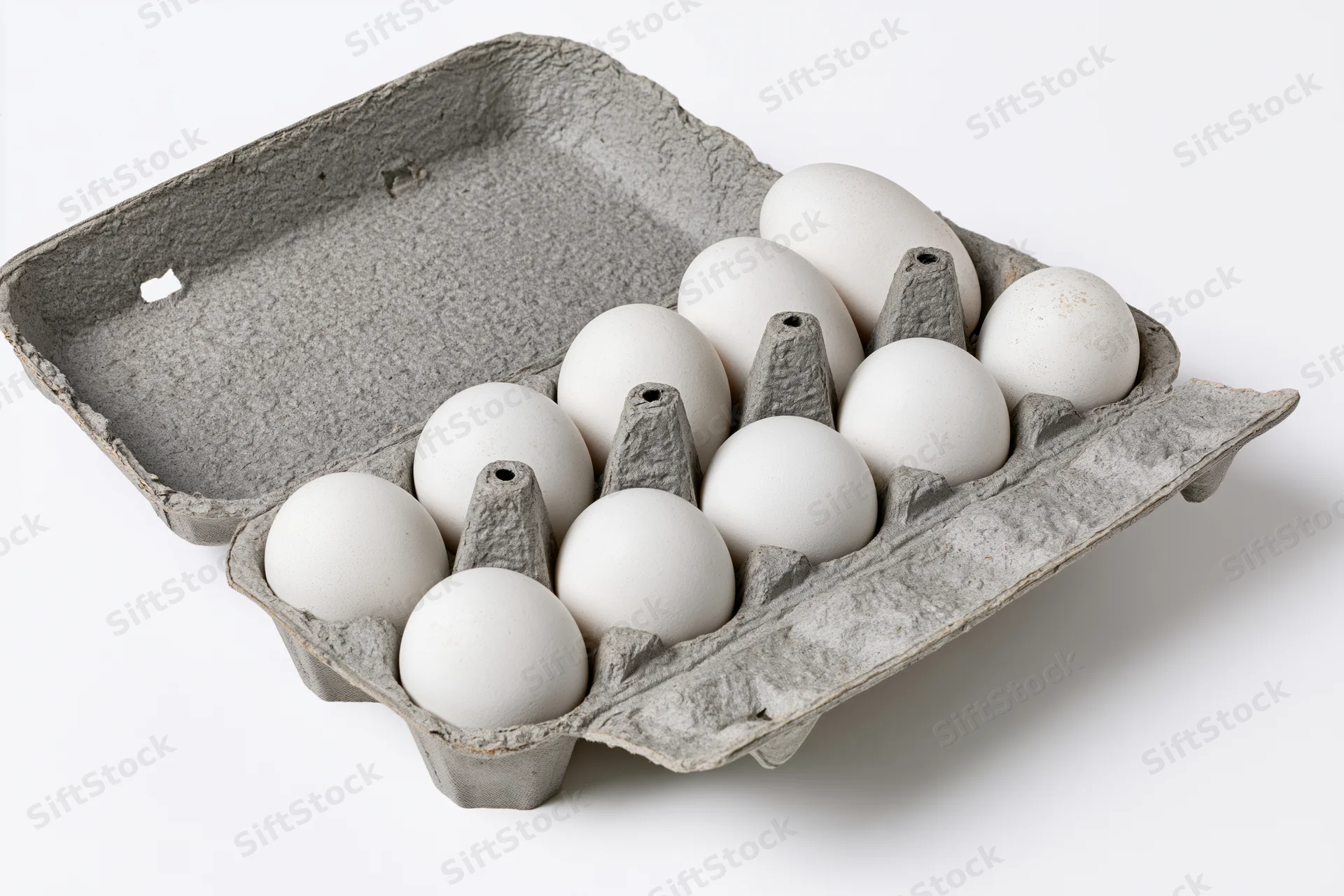 Open gray recycled cardboard egg carton holding ten white eggs on white background