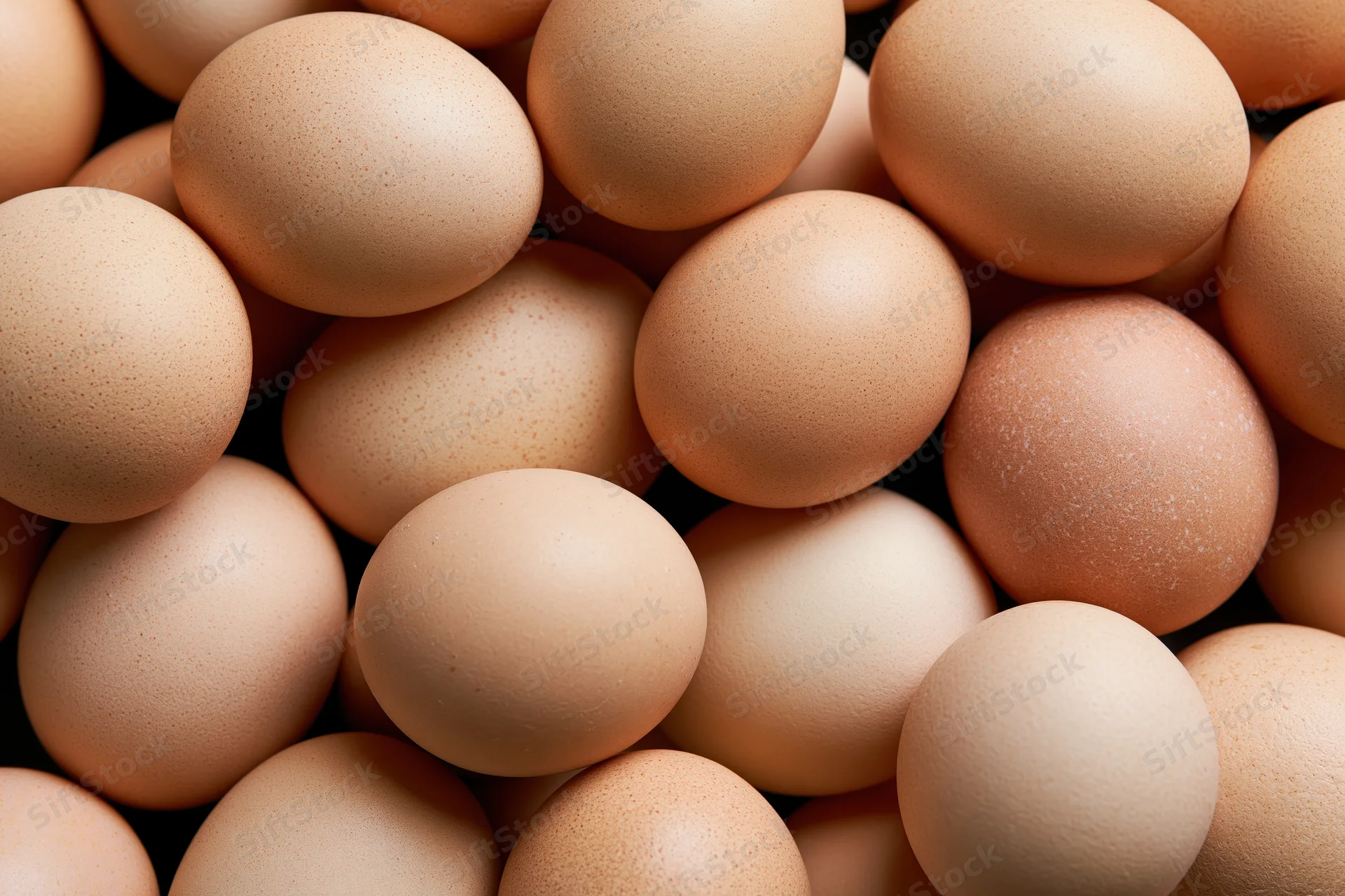 Pile of brown chicken eggs filling the frame from top view