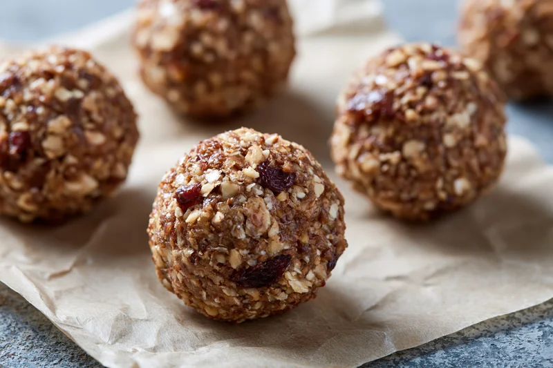 No-bake oat and date energy balls arranged on crumpled parchment paper