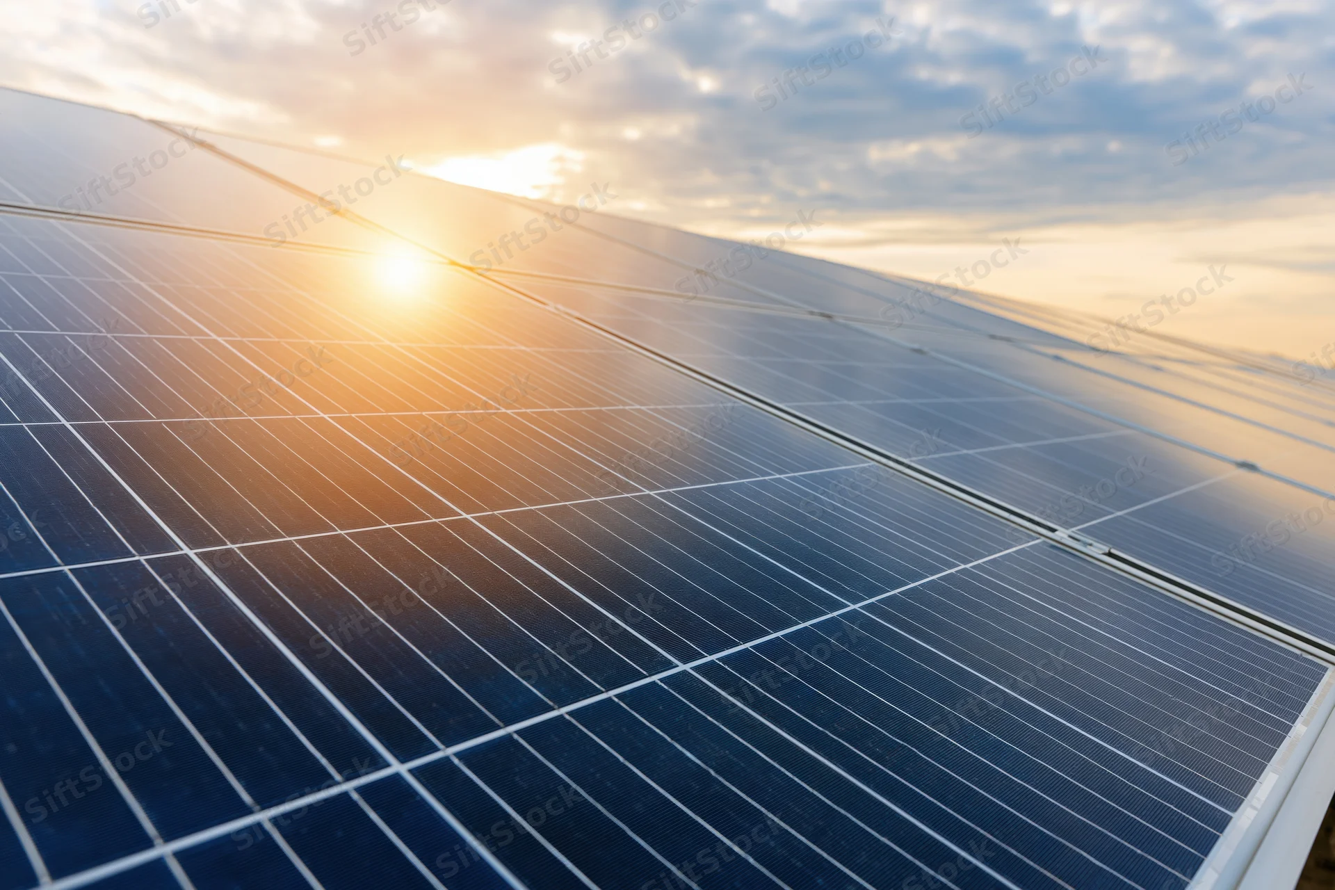 Solar panels angled toward the sky at sunset, capturing sunlight for energy generation