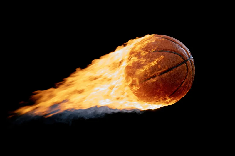 Basketball engulfed in flames streaking across black background