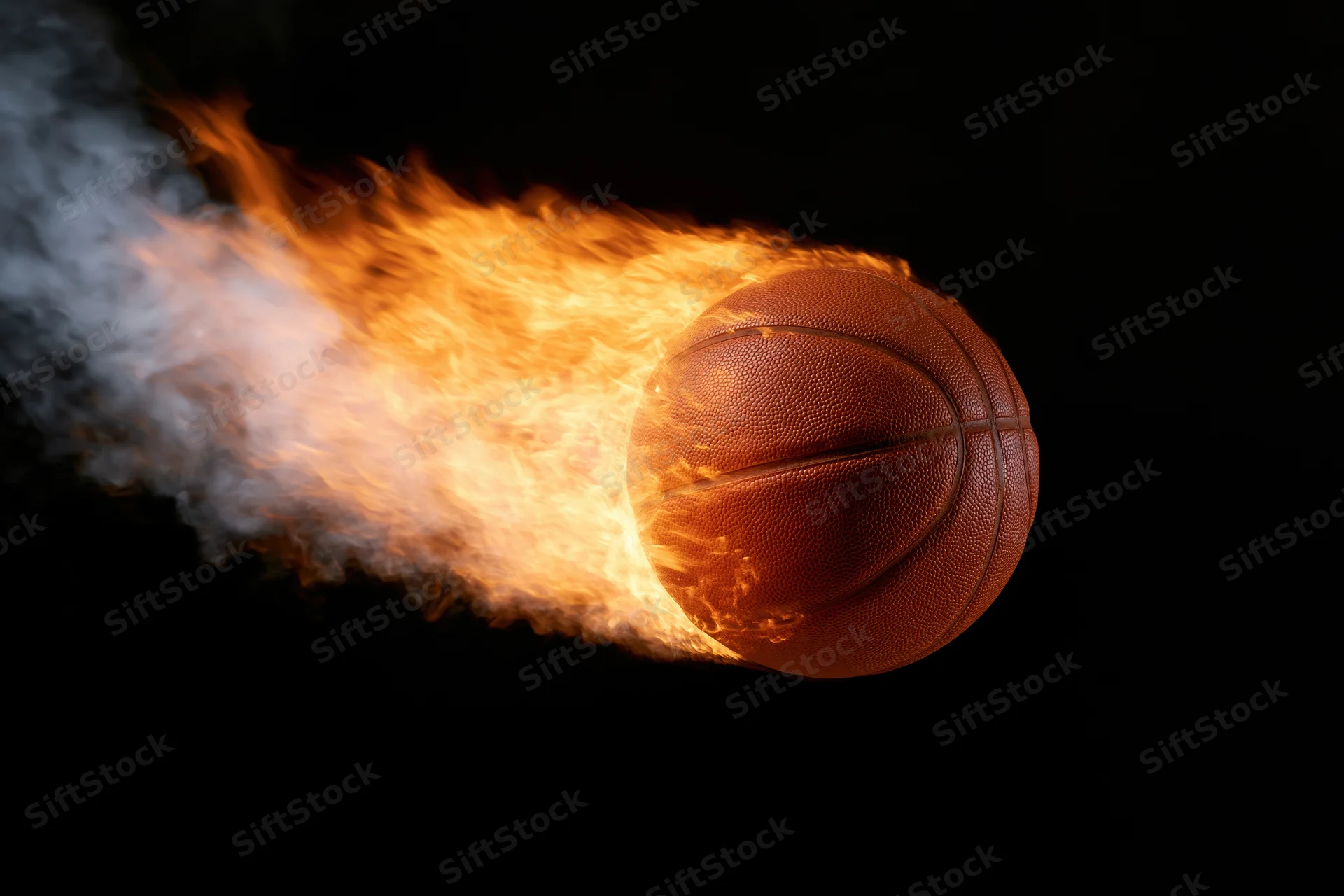 Basketball engulfed in flames streaking through black background
