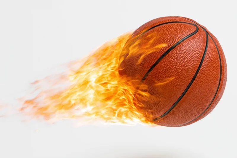 Basketball engulfed in flames streaking through the air against a white background